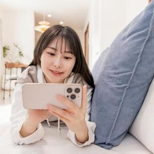 Lying face down, using a smartphone